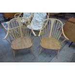 A pair of Ercol Blonde elm and beech 514 model Windsor cowhorn armchairs