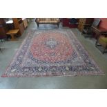 A large eastern red ground rug, 402 x 297cms