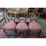 A set of six Victorian walnut balloon back dining chairs