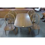 An Ercol Golden Dawn elm and beech Windsor drop leaf table and four chairs