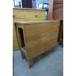 A teak drop leaf table