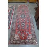 A vintage Persian red ground Hamadan village runner rug, 310 x 120cms