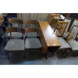 A teak drop leaf table and six chairs