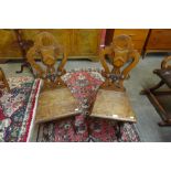 A pair of Victorian Gothic Revival oak hall chairs