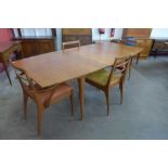 A McIntosh teak boat shaped extending dining table and four chairs