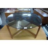 A teak and glass topped circular coffee table