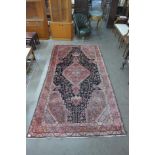 A vintage Persian pink ground Hamadan village rug, 293 x 162cms