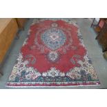A vintage Persian red ground Tabriz rug, 360 x 234cms