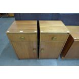 A pair of teak bedside cabinets