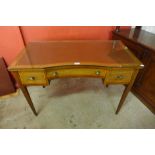 A late Victorian inlaid mahogany and leather topped writing table