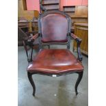 A French Louis XV style ebonised and red leather library chair