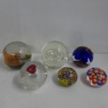 Four Caithness glass paperweights and two millefiori paperweights