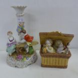 A continental figural candlestick and one other figure of two children in a basket