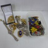 A small box of costume jewellery including brooches, earrings, etc.