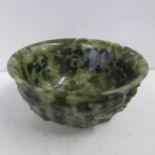 A Chinese spinach jade marriage bowl, depicting two dragons, chip to rim, circa 1900