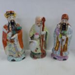 Three oriental figures, tallest 30cm