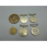 Three WWII medals, a commemorative George V medallion, etc.