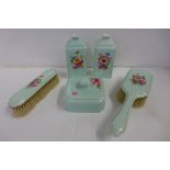 An early 20th Century Worcester dressing table set comprising powder pot, clothes and hair brush and