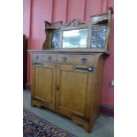 An Arts and Crafts oak and copper mounted mirrorback sideboard