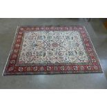 A Persian hand knotted cream ground Tabriz rug, 188cms x 140cms