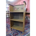 A small Arts and Crafts oak open bookcase, attributed to C.F.A. Voysey for Liberty & Co.
