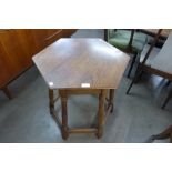 An Arts and Crafts oak hexagonal occasional table