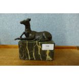 A small bronze figure of a deer, on grey marble socle, 15cms h