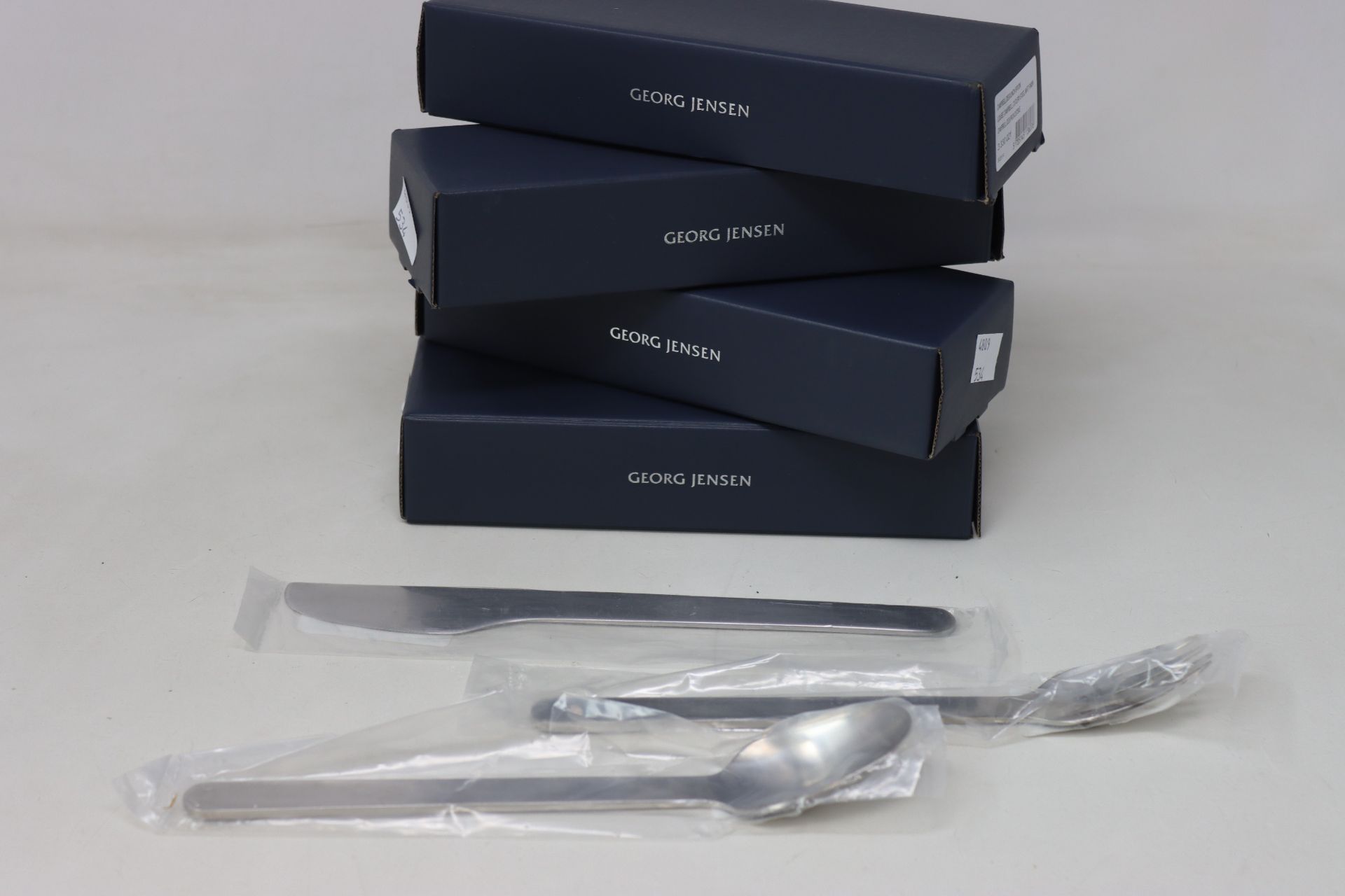 A quantity of as new Georg Jensen Louise Campbell cutlery to include dinner knives and forks,