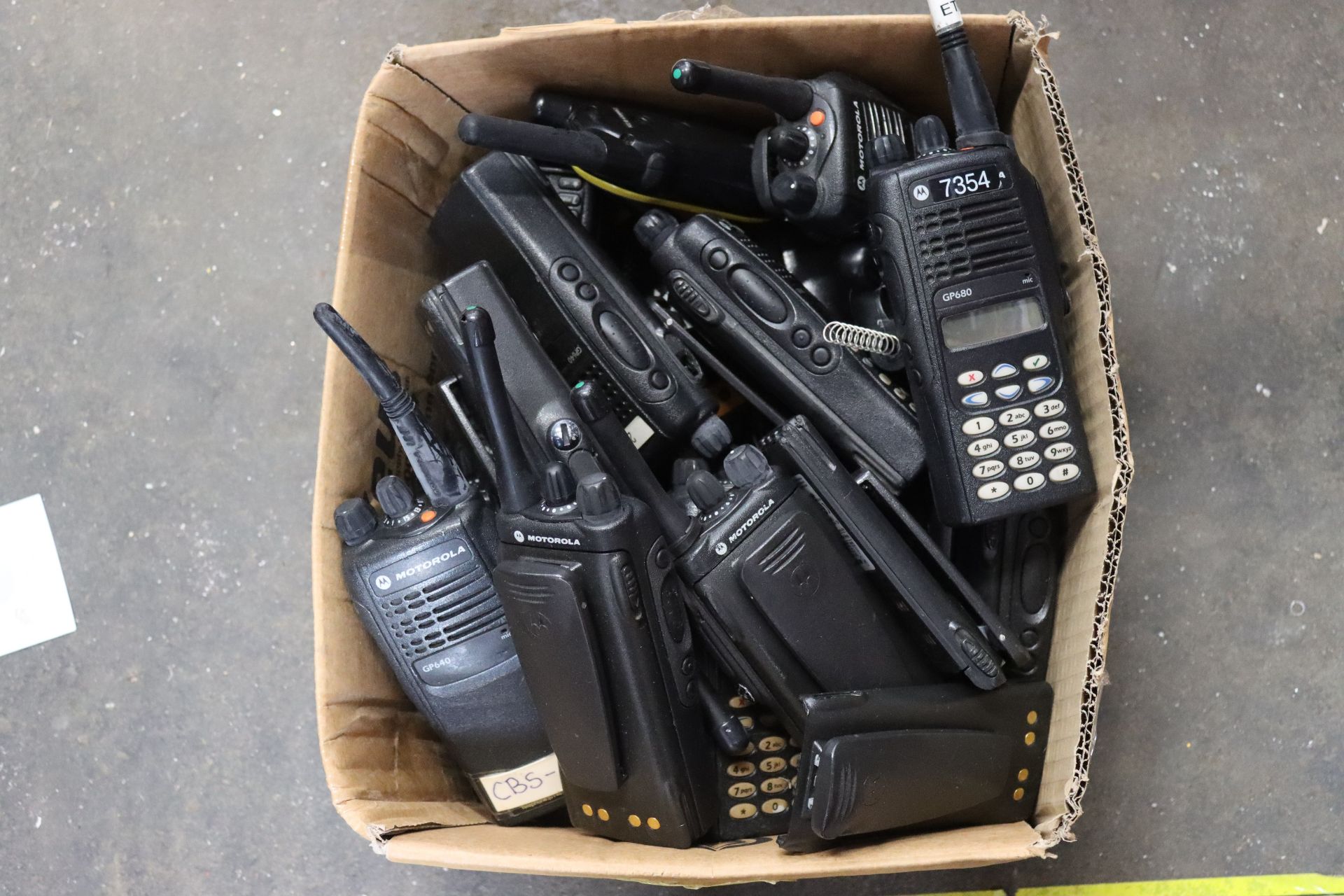 A quantity of pre-owned miscellaneous portable two-way radios and related items to include