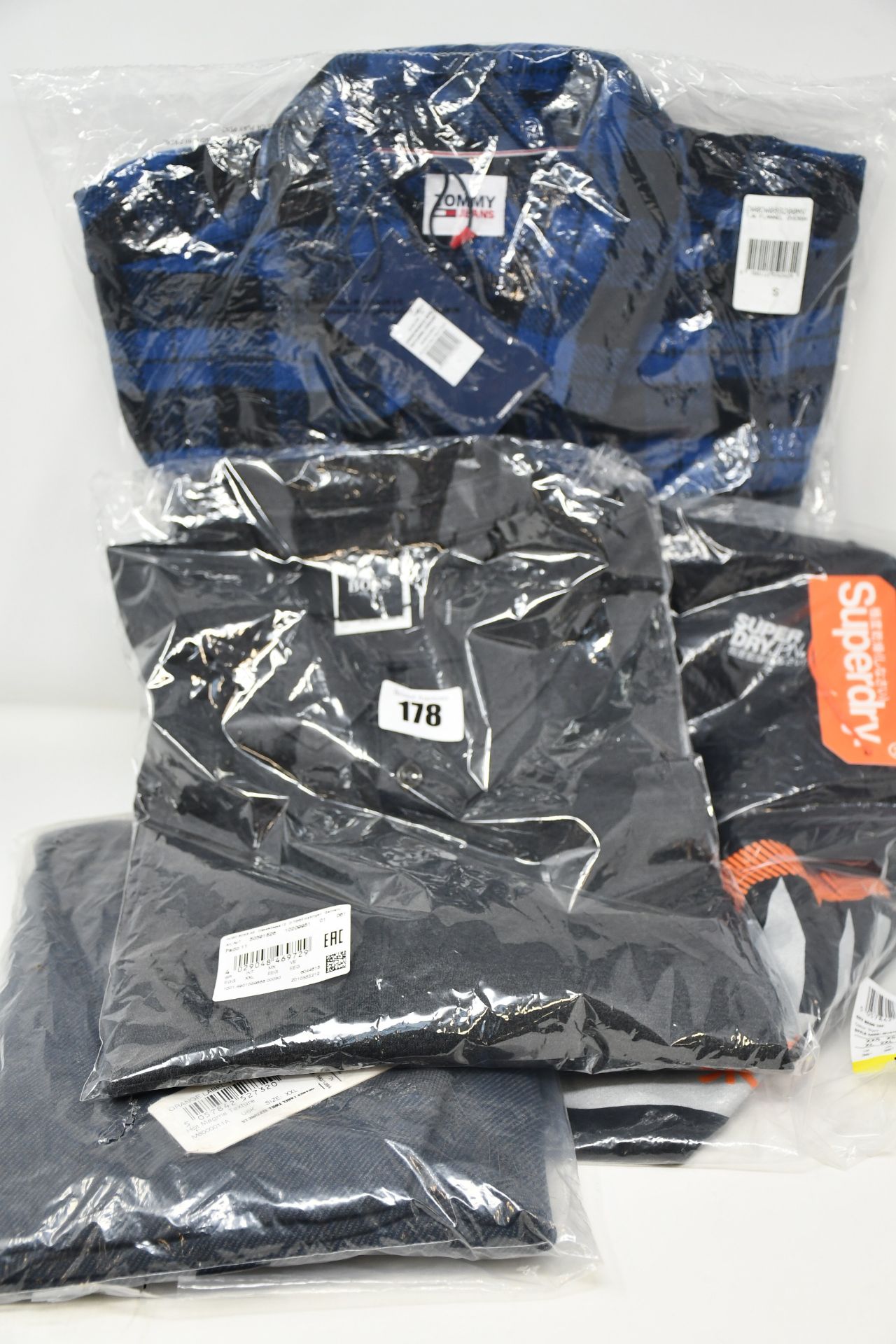 An as new Hugo Boss polo shirt (XXL), Tommy Jeans flannel overshirt (S) and two Superdry tops (M and