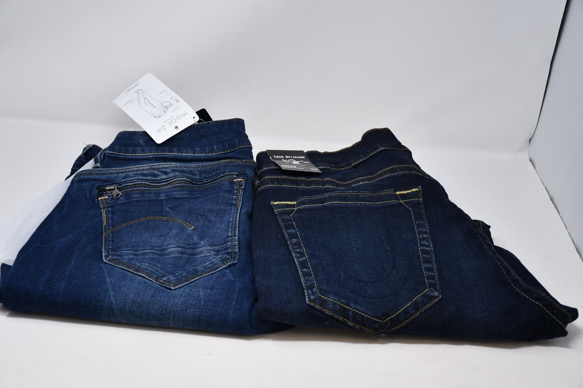 A pair of women's as new G-Star G Raw Midge zip mid skinny size 34/36 and a pair of men's as new