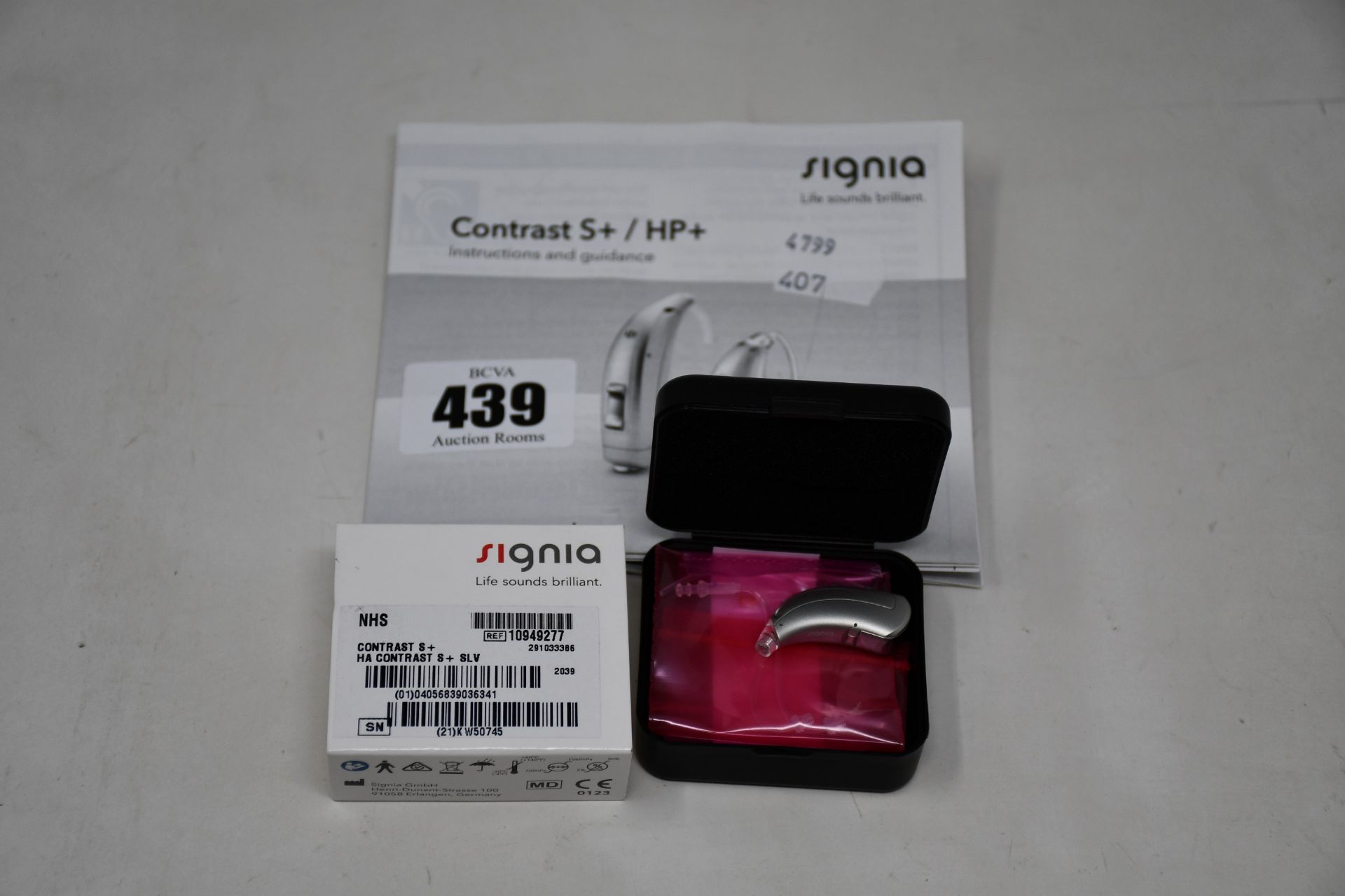 A boxed as new Signia Contrast S+ hearing aid in silver.