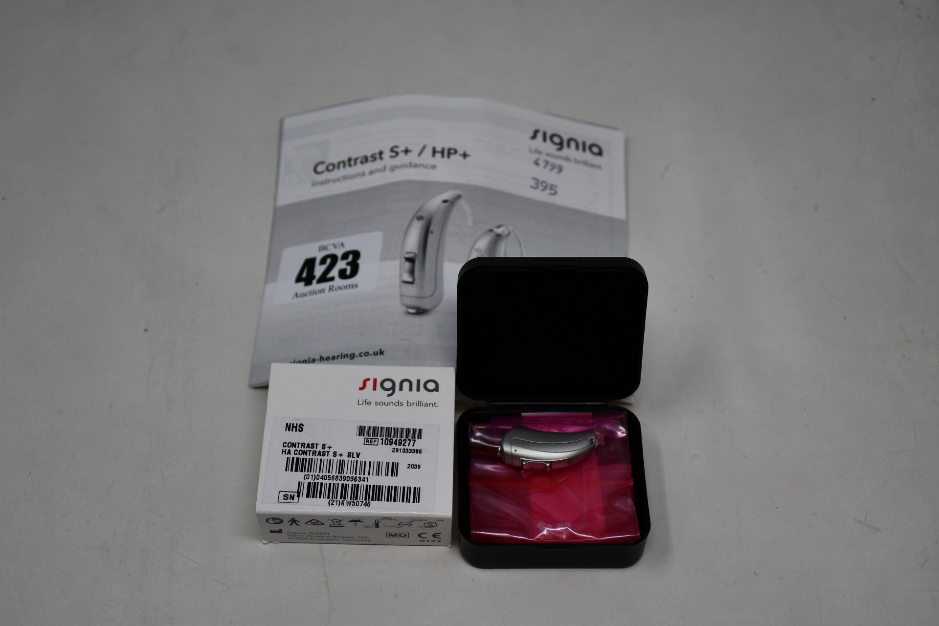 A boxed as new Signia Contrast S+ hearing aid in silver.