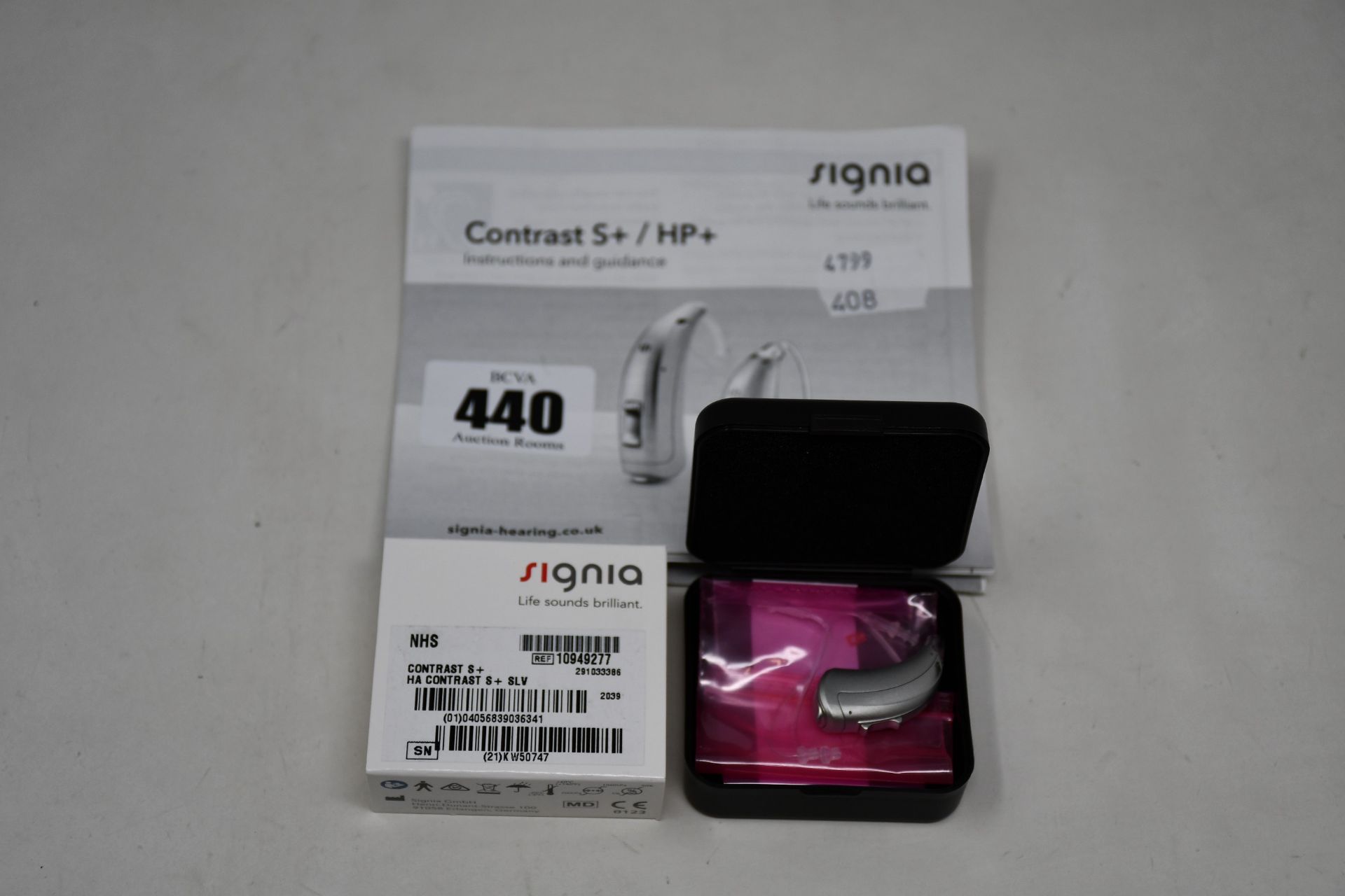 A boxed as new Signia Contrast S+ hearing aid in silver.