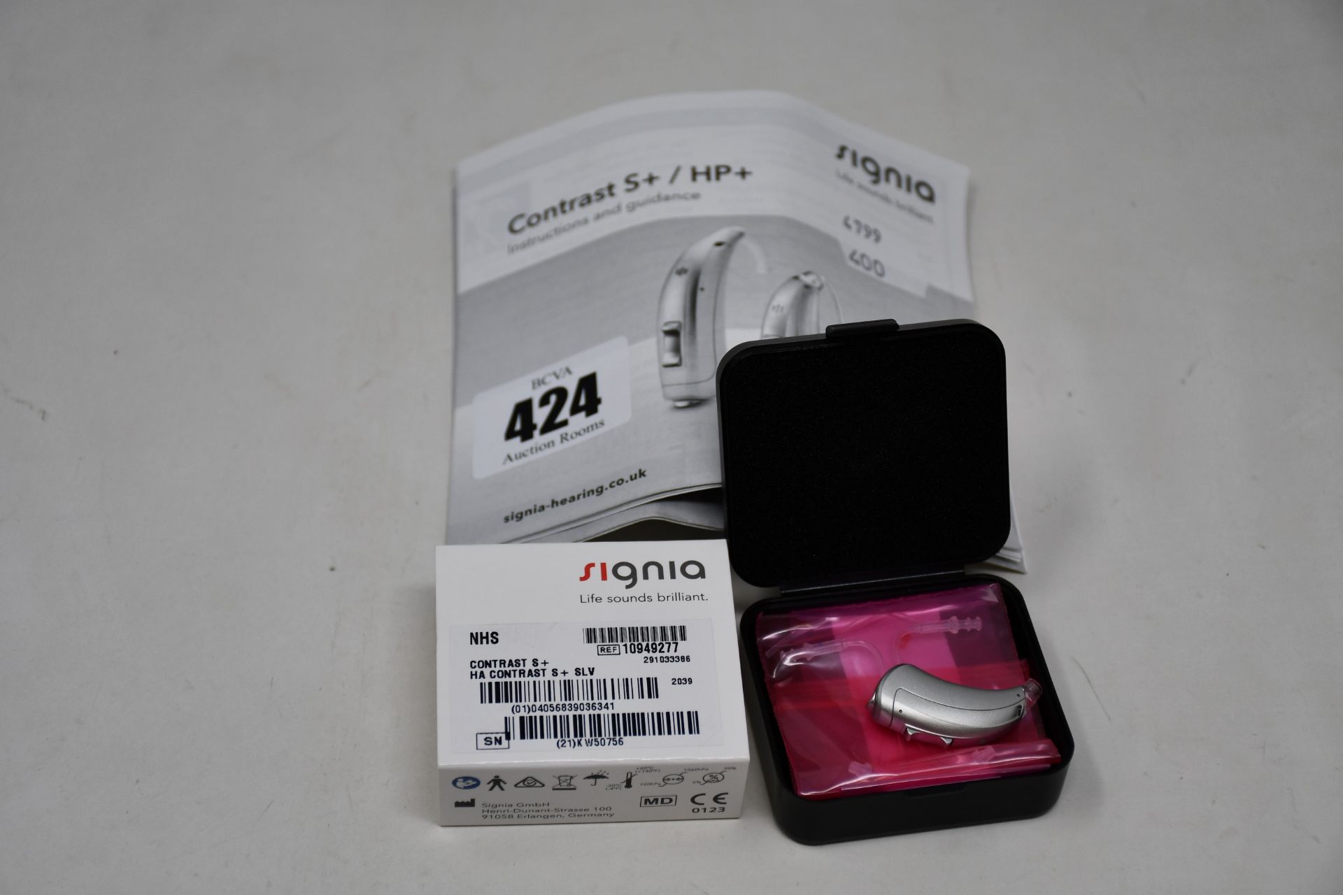 A boxed as new Signia Contrast S+ hearing aid in silver.