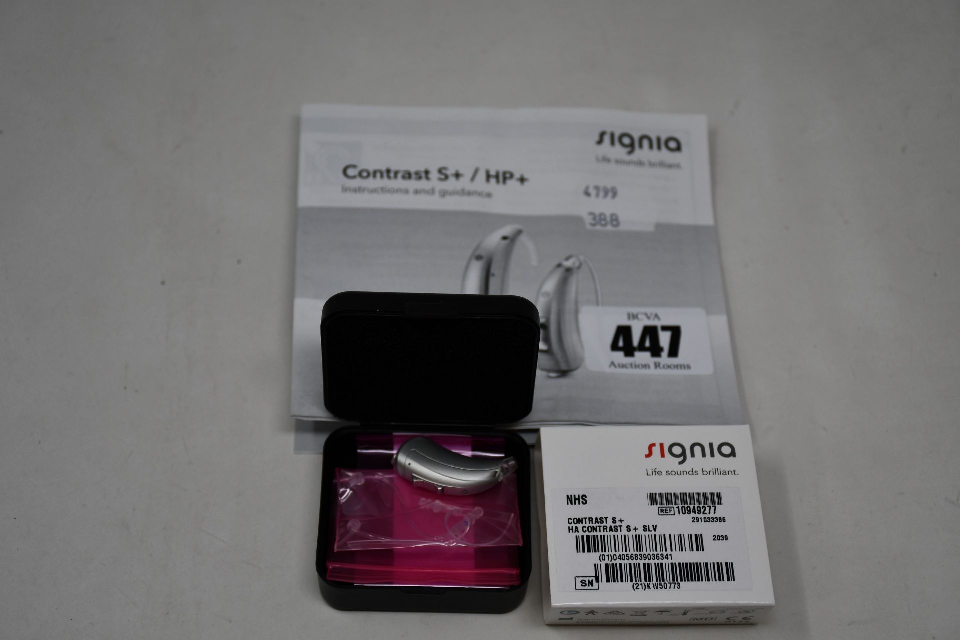 A boxed as new Signia Contrast S+ hearing aid in silver.