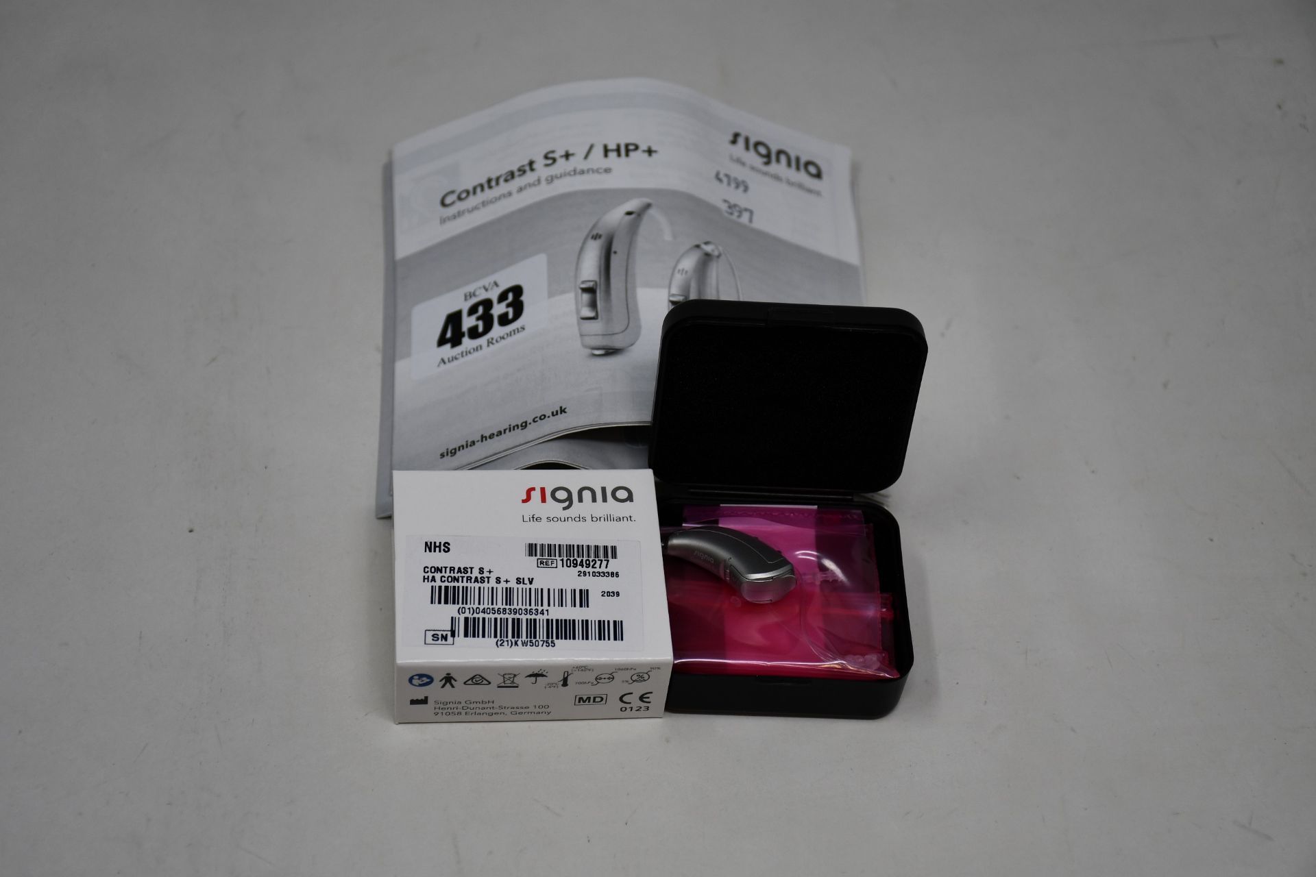 A boxed as new Signia Contrast S+ hearing aid in silver.