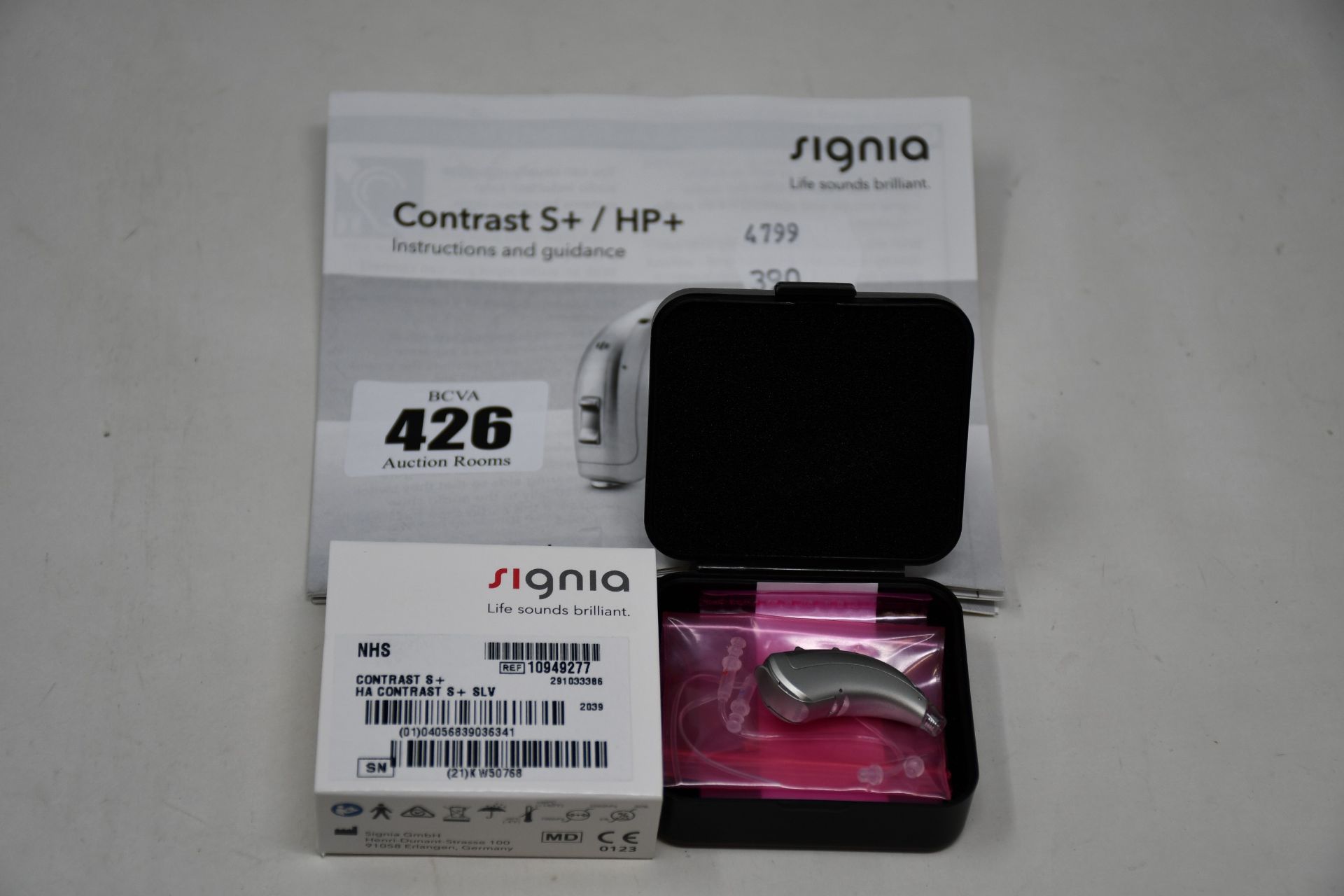 A boxed as new Signia Contrast S+ hearing aid in silver.