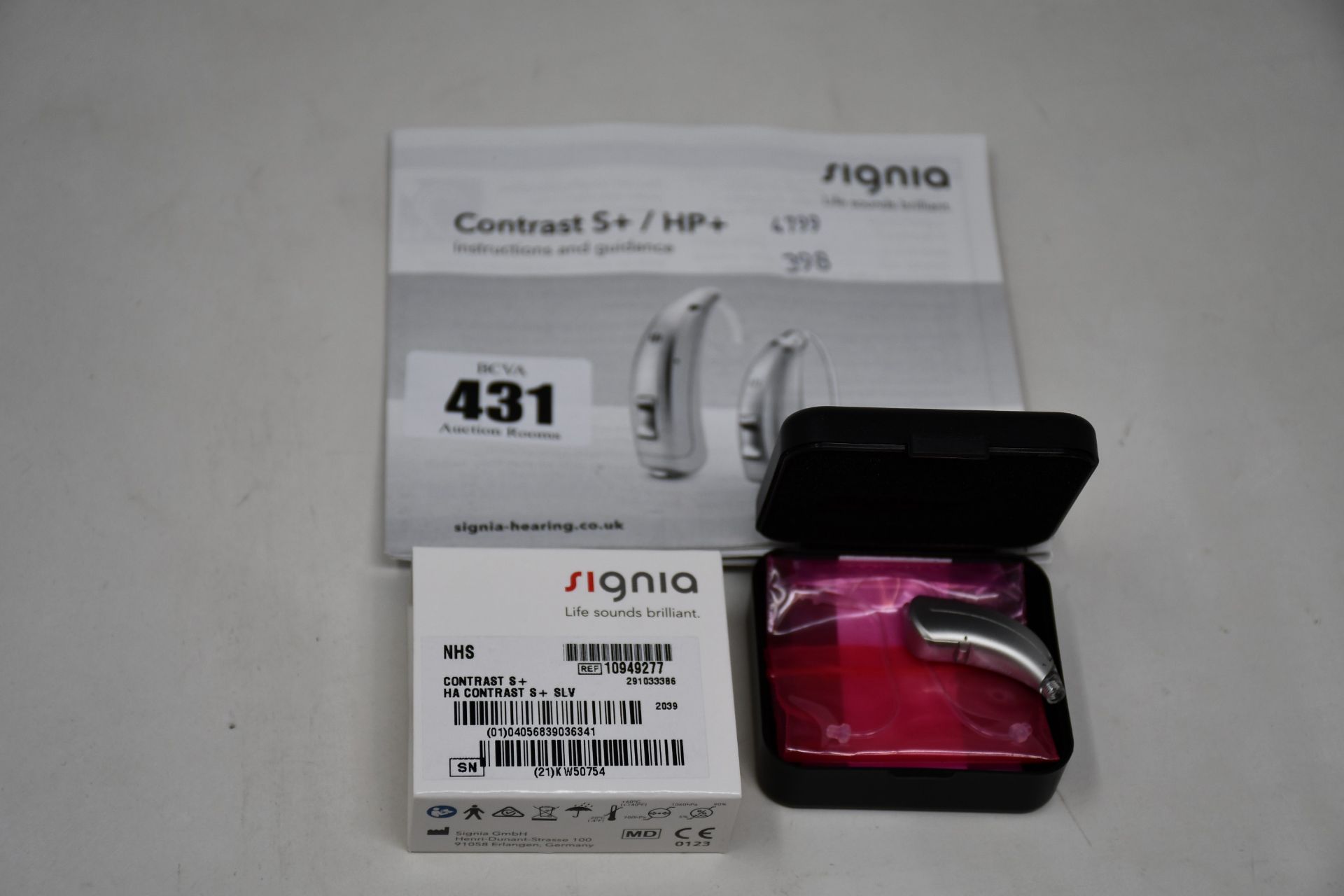 A boxed as new Signia Contrast S+ hearing aid in silver.