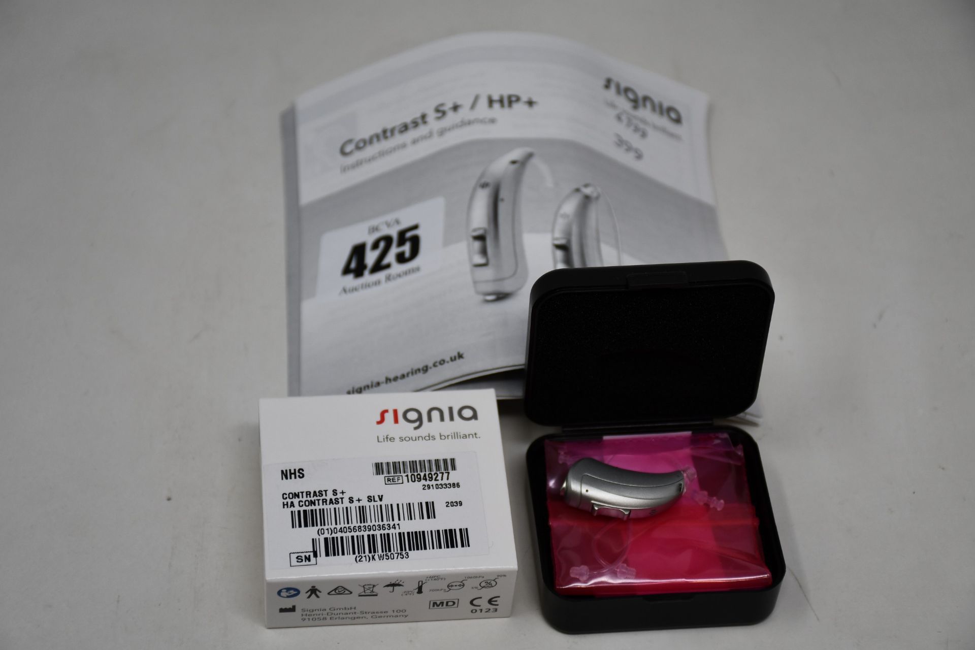 A boxed as new Signia Contrast S+ hearing aid in silver.