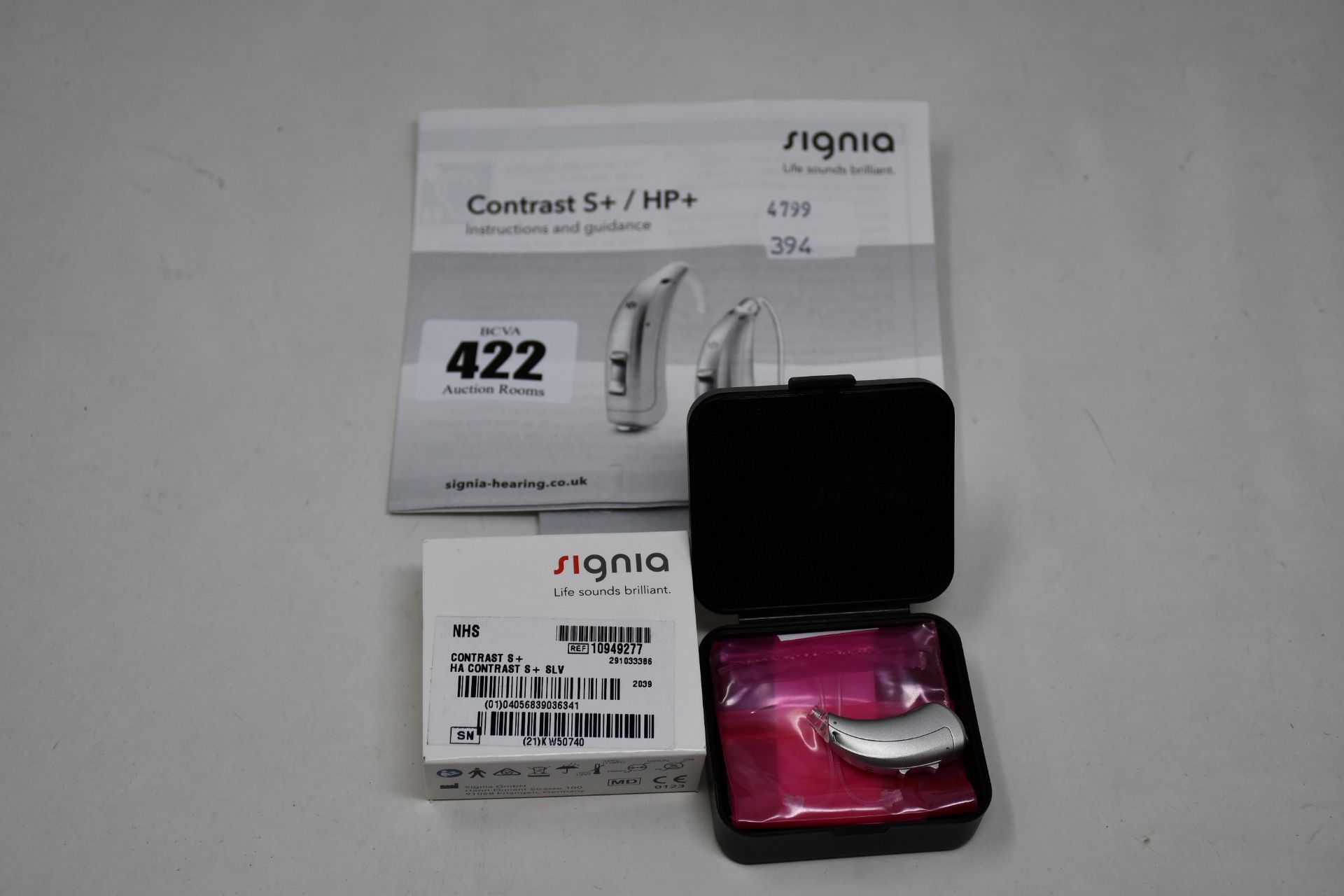 A boxed as new Signia Contrast S+ hearing aid in silver.