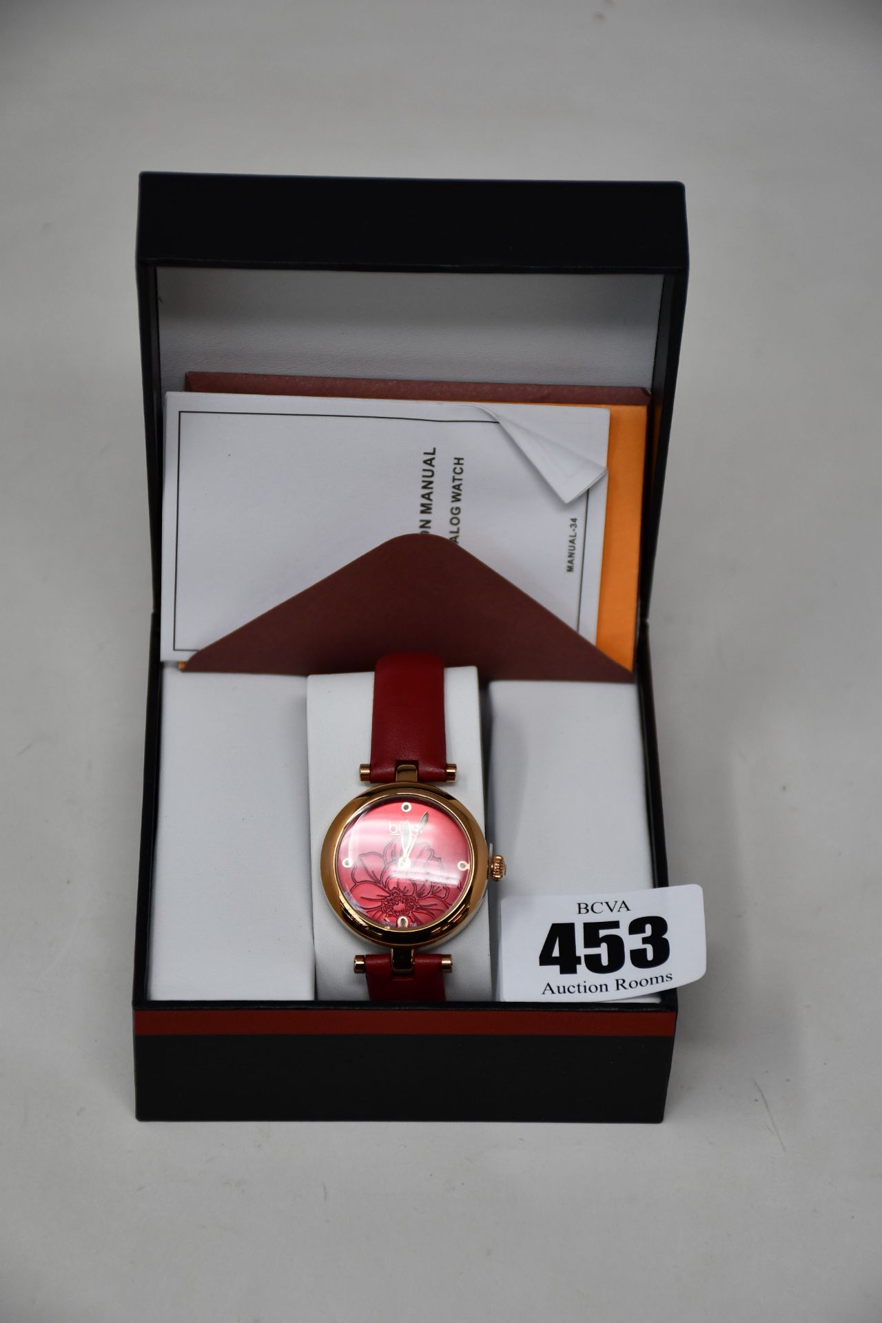 A women's boxed Burgi Artist Pure Essence watch with leather strap.