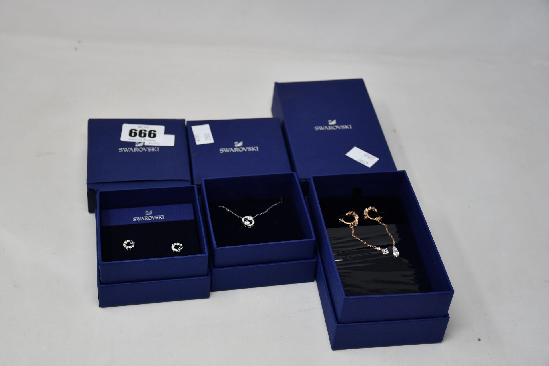 Three boxed as new Swarovski jewellery items to include one attract pierced earrings white and