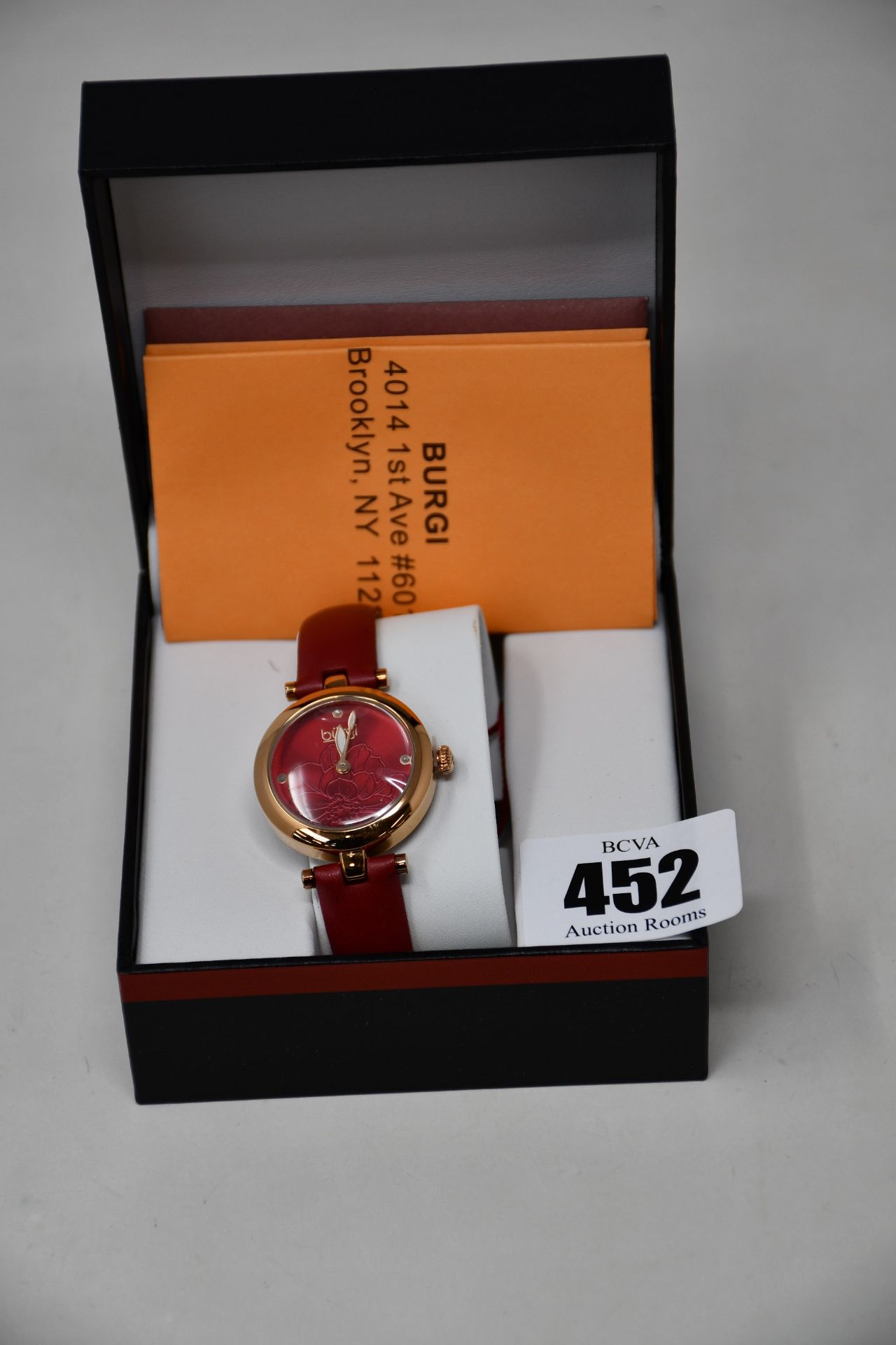 A women's boxed Burgi Artist Pure Essence watch with leather strap.