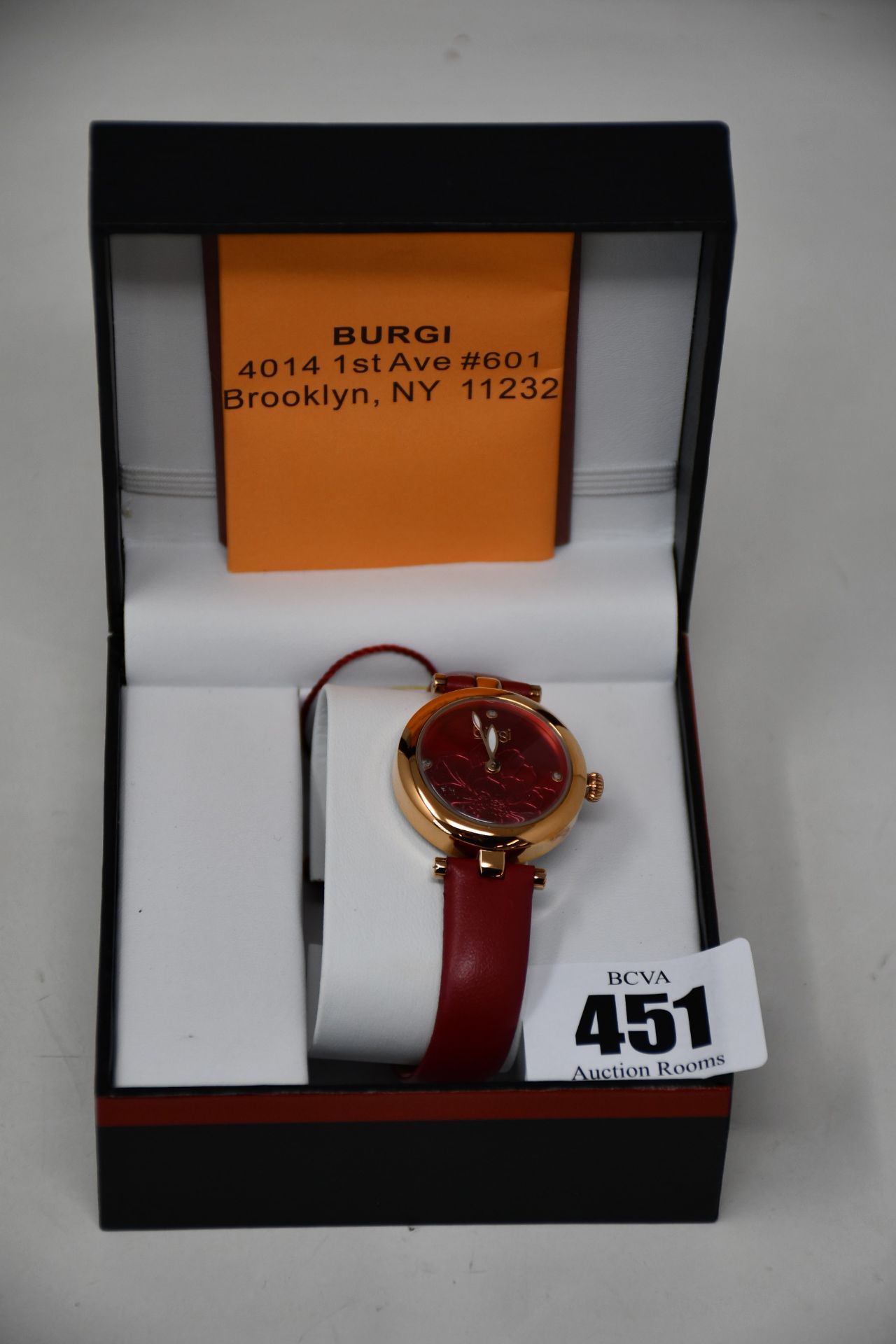 A women's boxed Burgi Artist Pure Essence watch with leather strap.