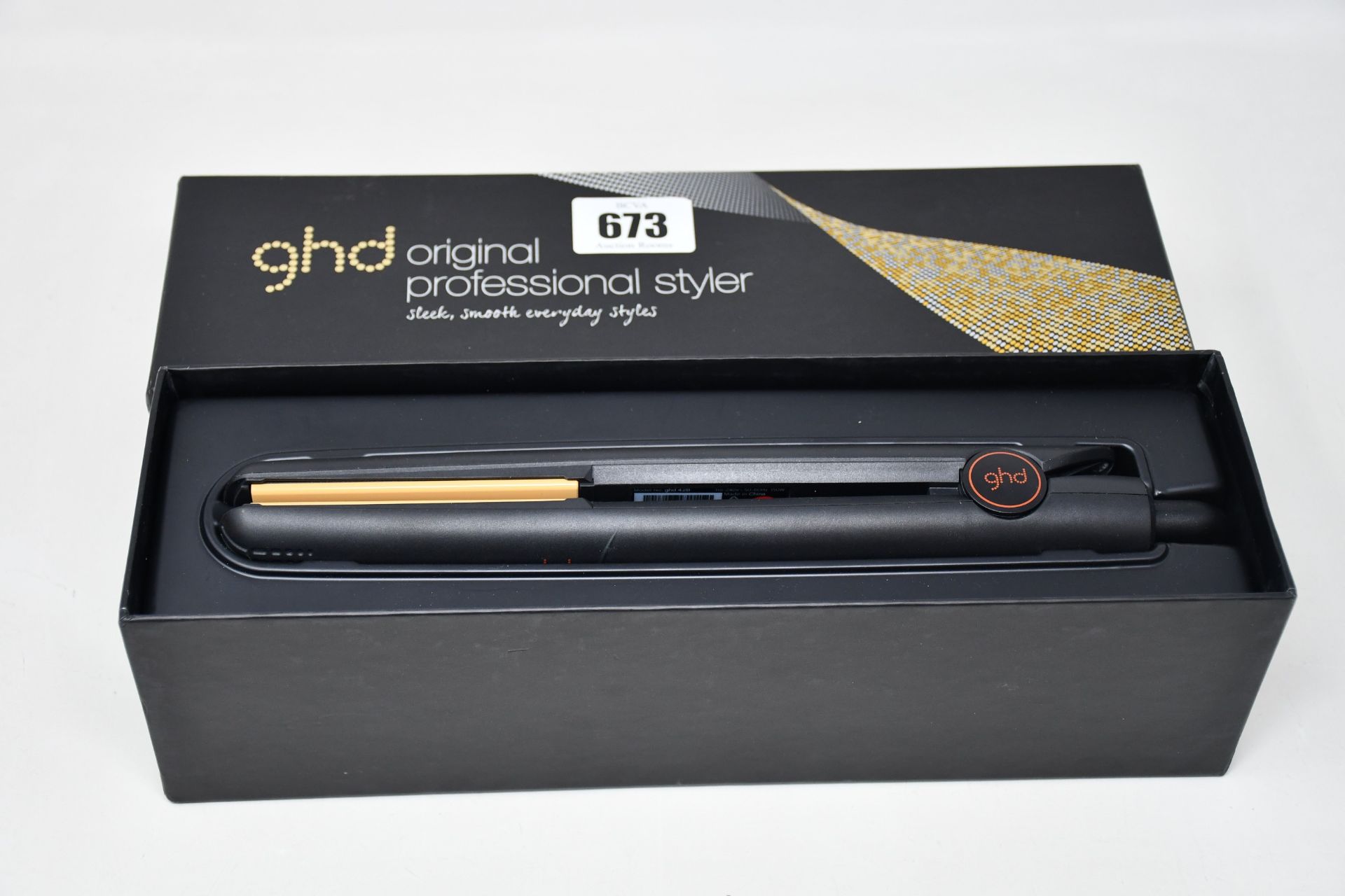 A pair of boxed GHD Original Professional Styler hair straighteners.