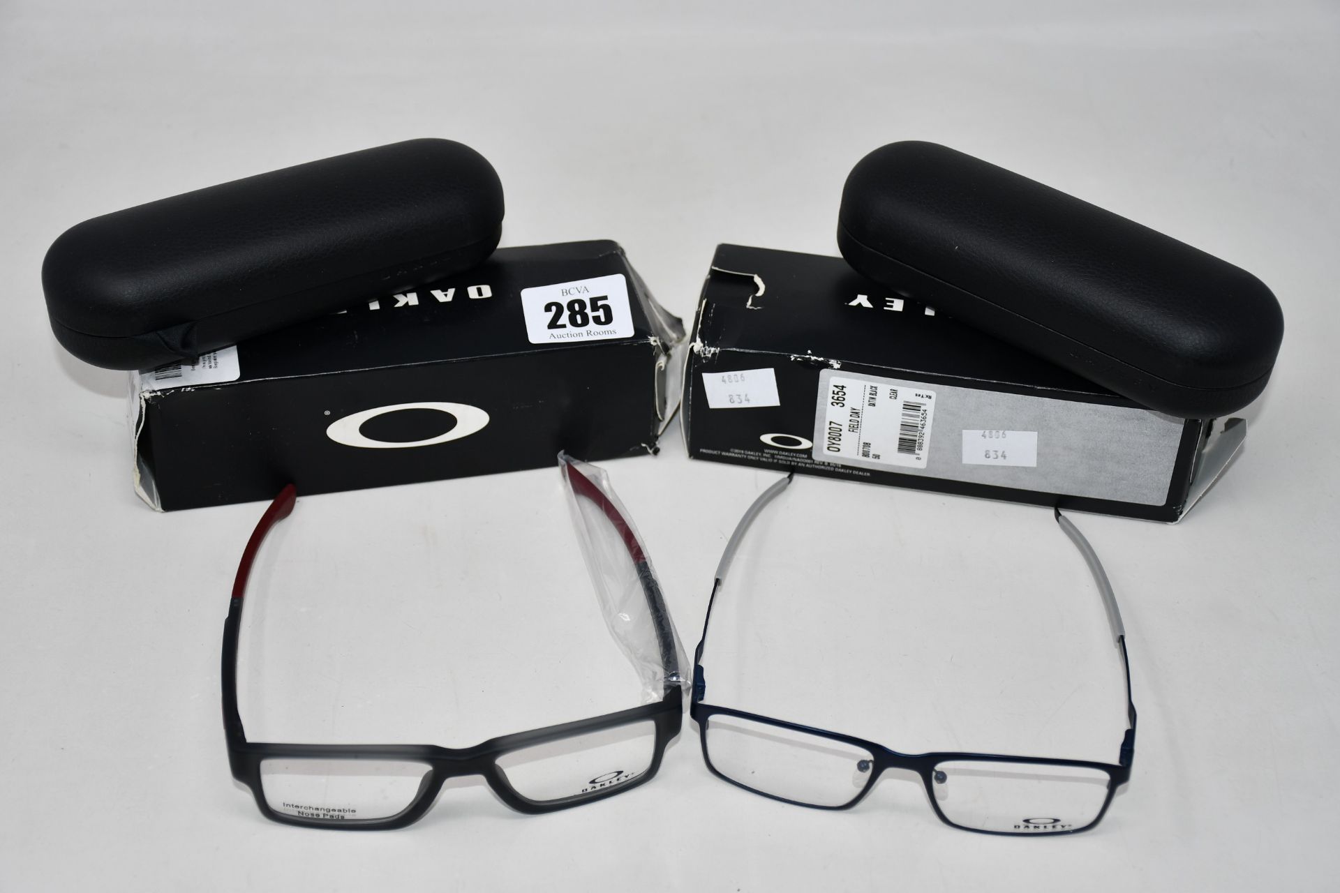 A pair of as new Oakley Airdrop Trubridge glasses frames and a pair of as new Oakley Field Day