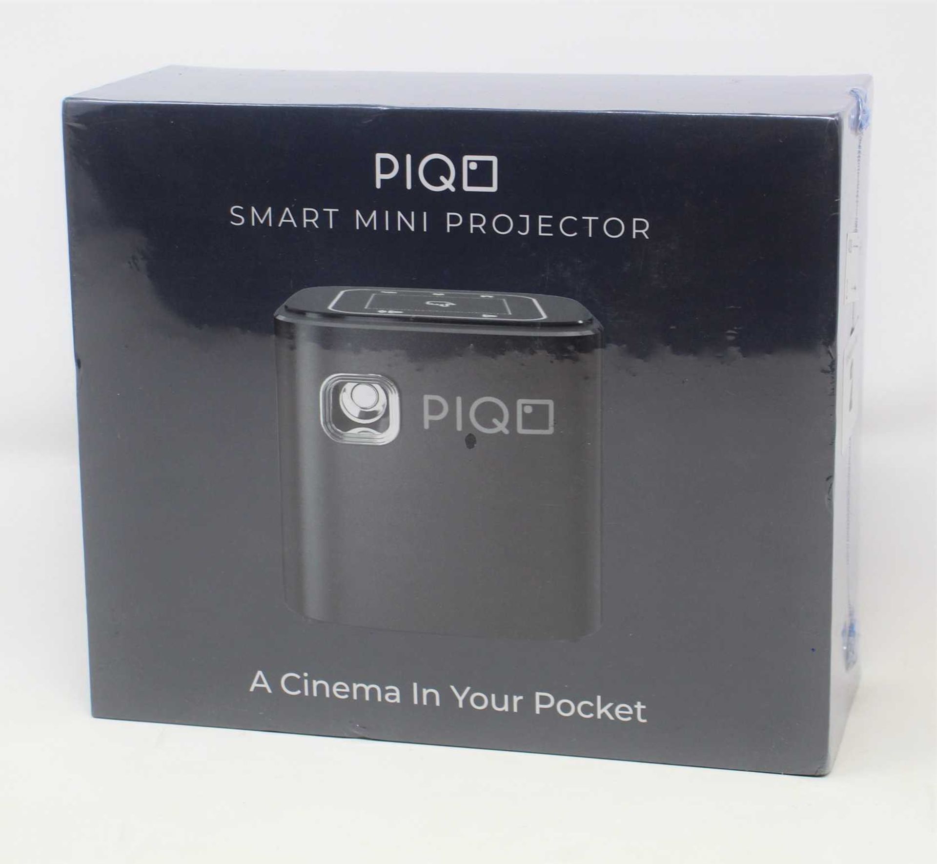 A boxed as new Piqo Smart Android Mini Projector (UK plug adaptor required) (Box sealed).