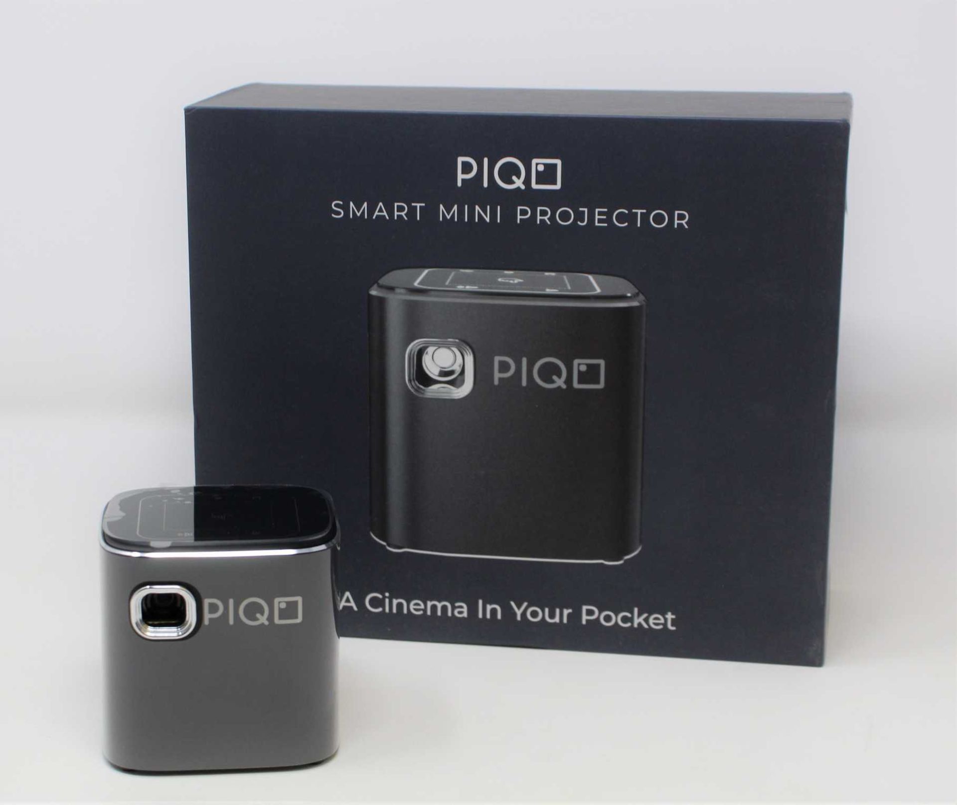 A boxed as new Piqo Smart Android Mini Projector (UK plug adaptor required) (Box opened).