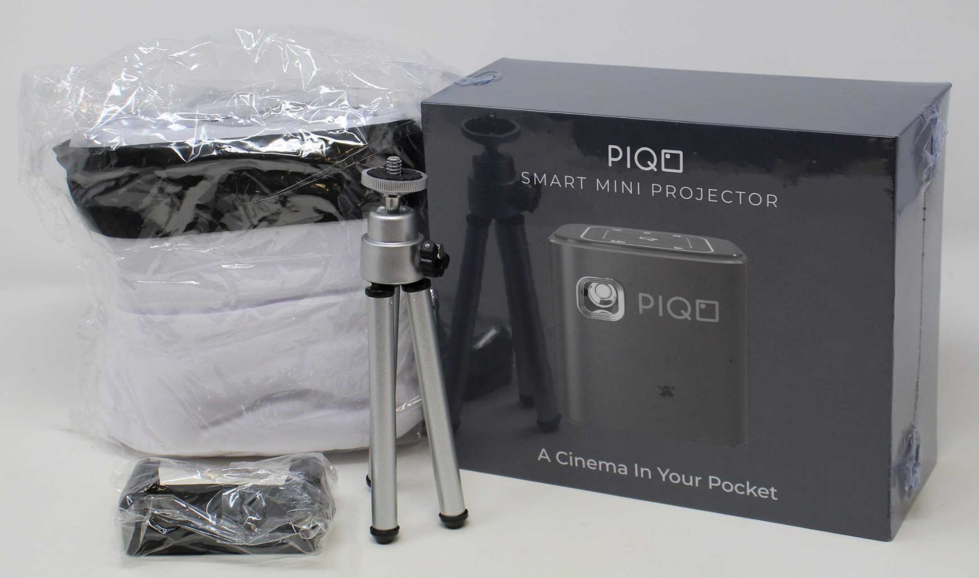 A boxed as new Piqo Smart Android Mini Projector (UK plug adaptor required) (Box sealed) with fabric